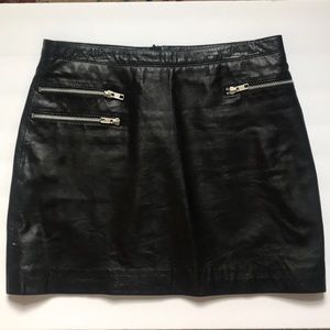 Black leather mini skirt with zipped pockets